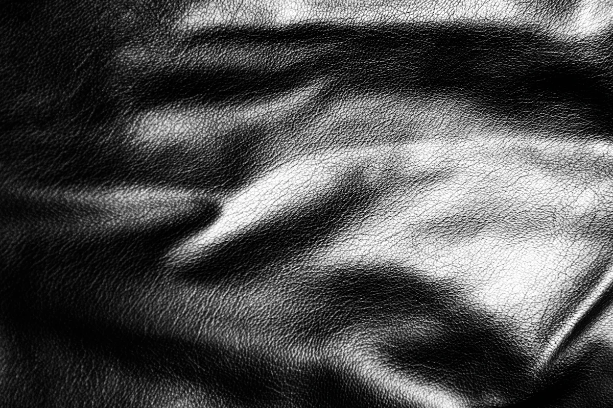 Black leather gathered in soft folds