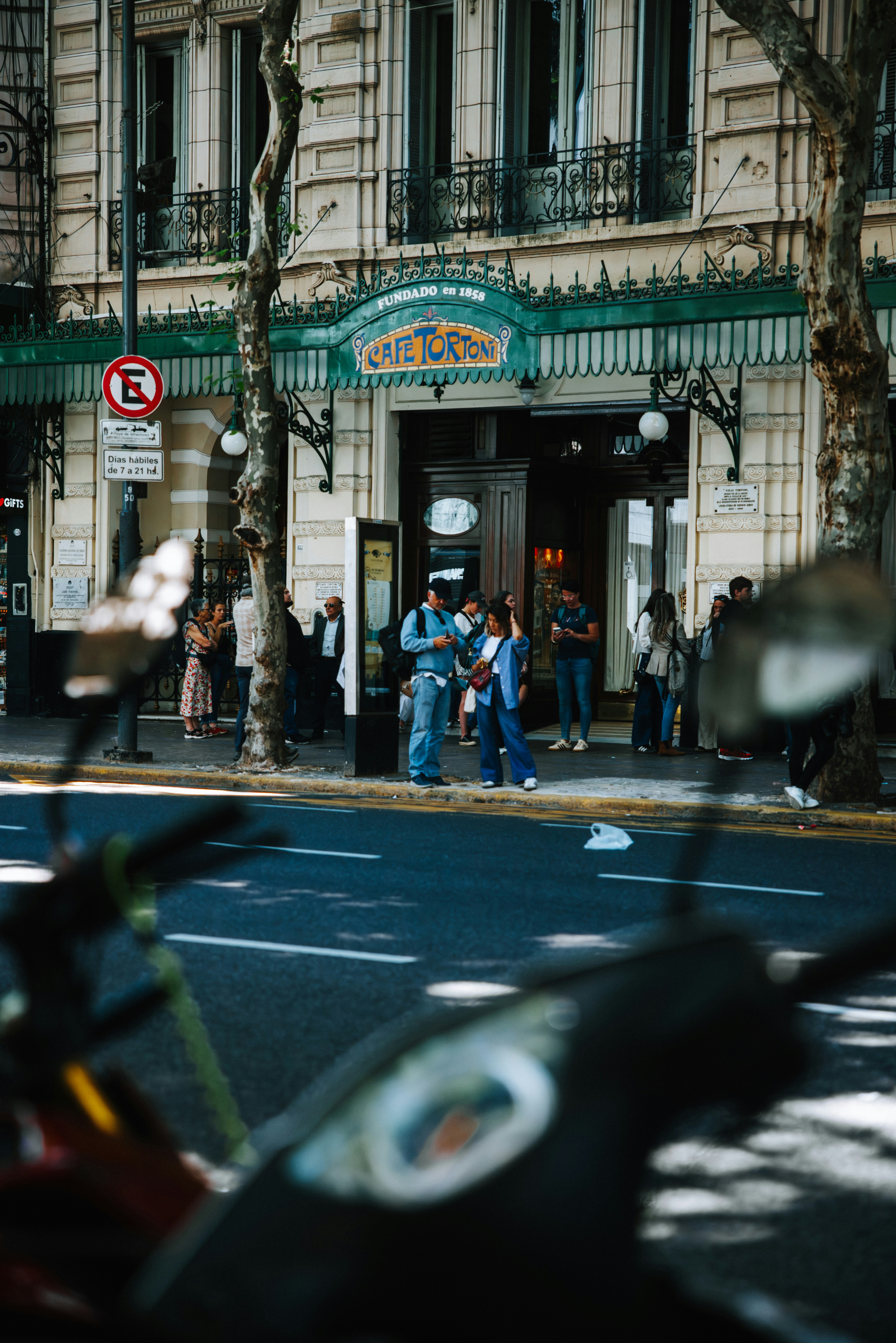 People outside a cafe on a sunny day