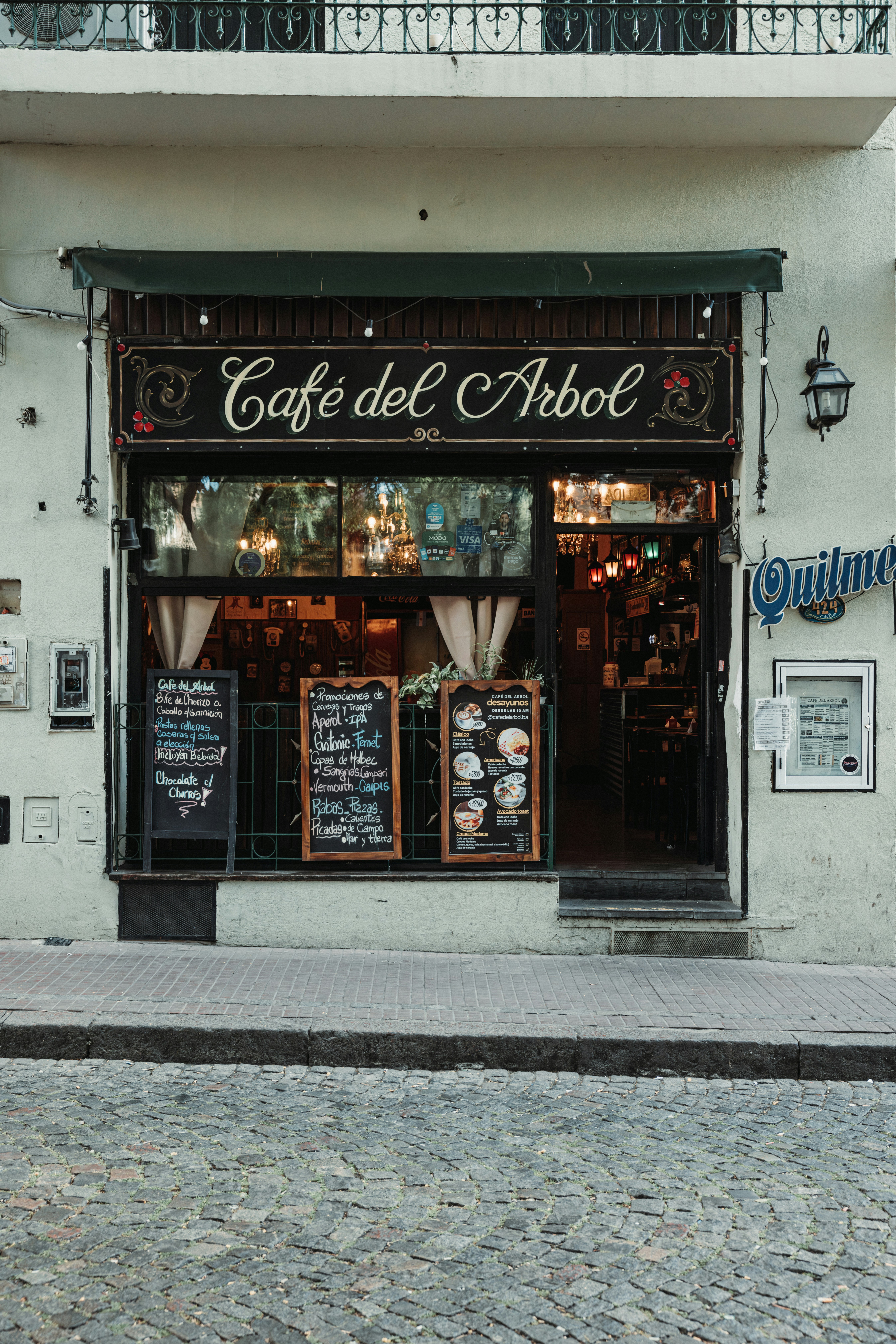 Cafe del arbol storefront with menu boards