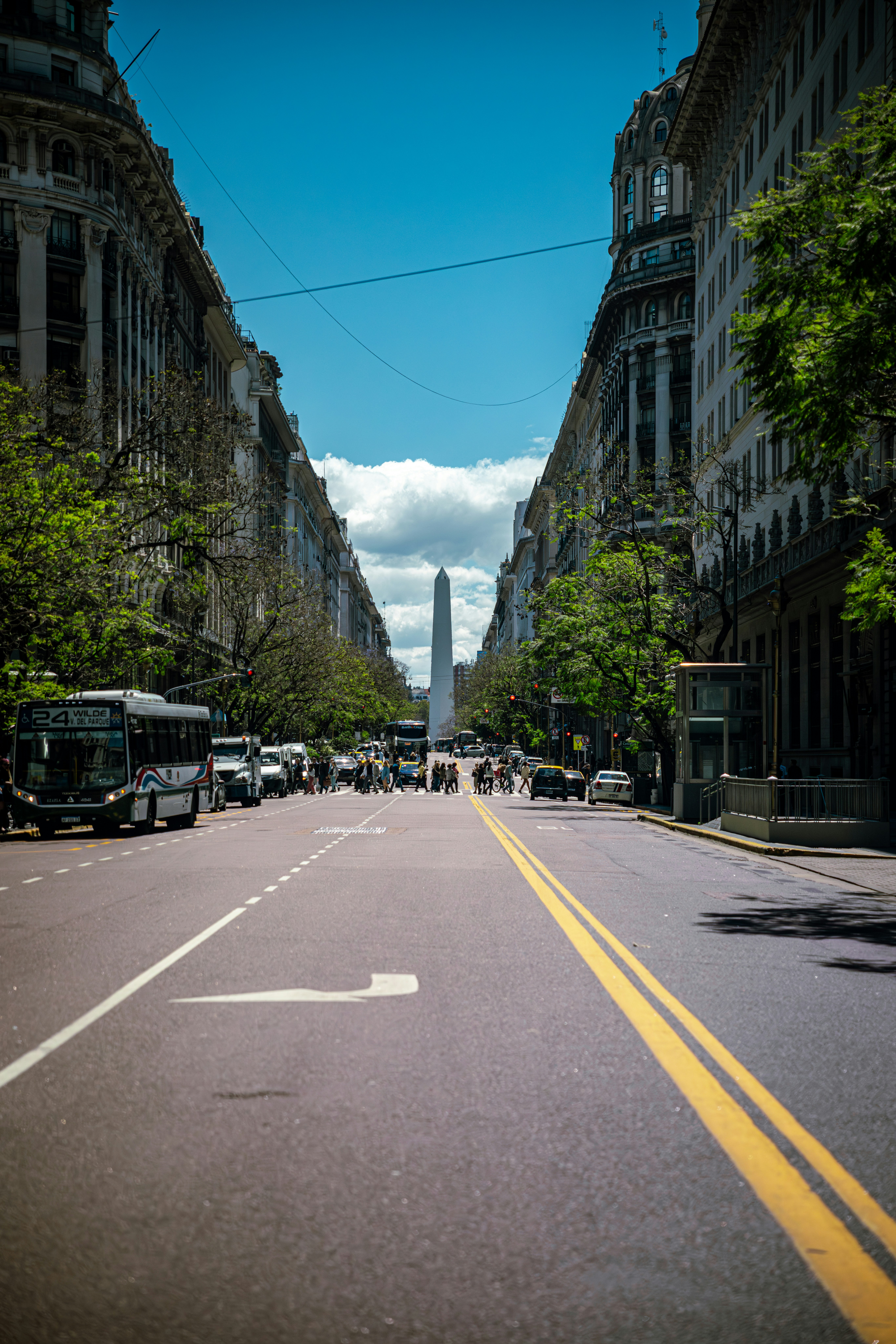 A wide street leading to an obelisk monument.