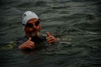 Man in water gives two thumbs up