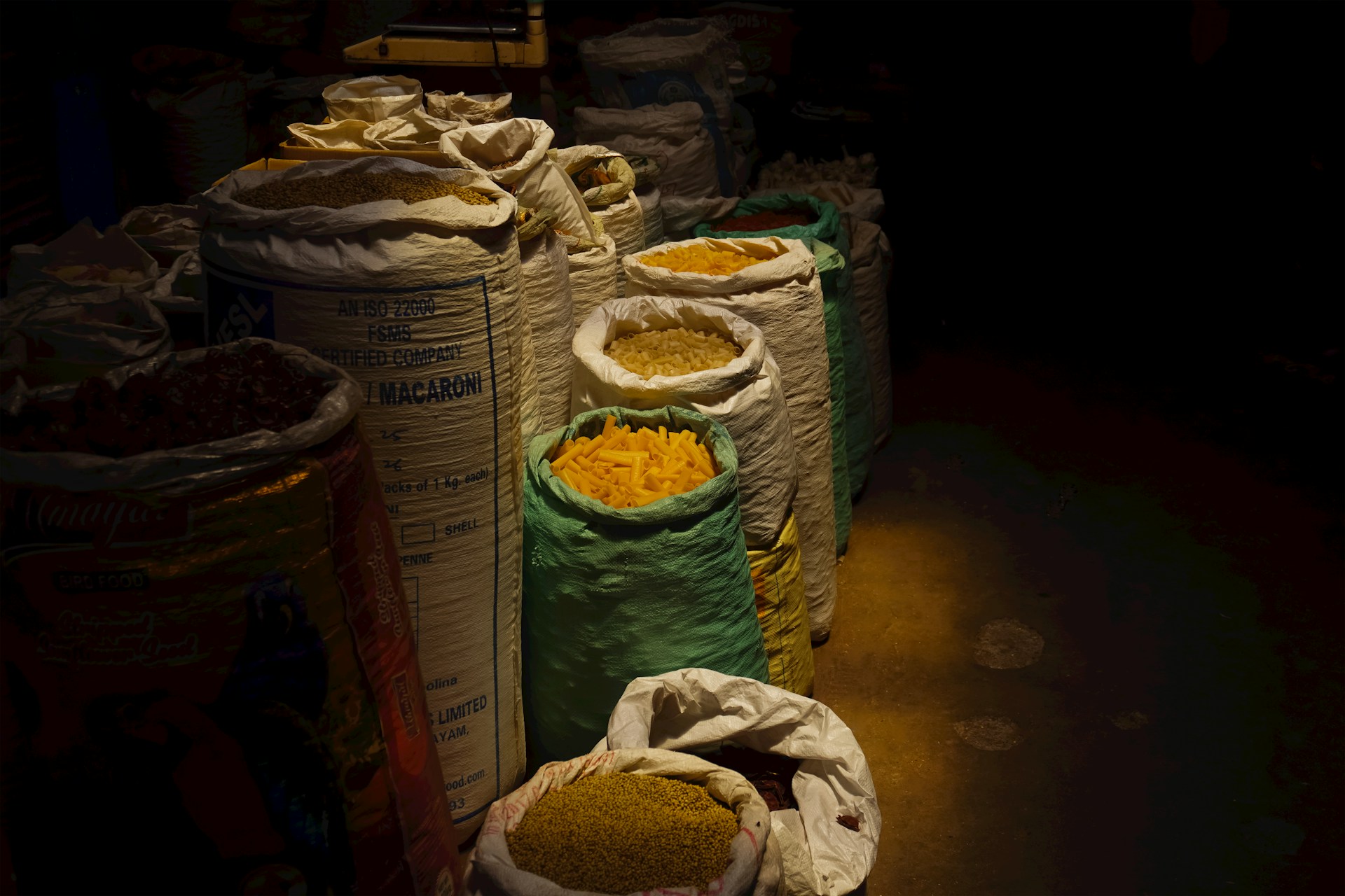 Sacks of grain in a dimly lit storage area.