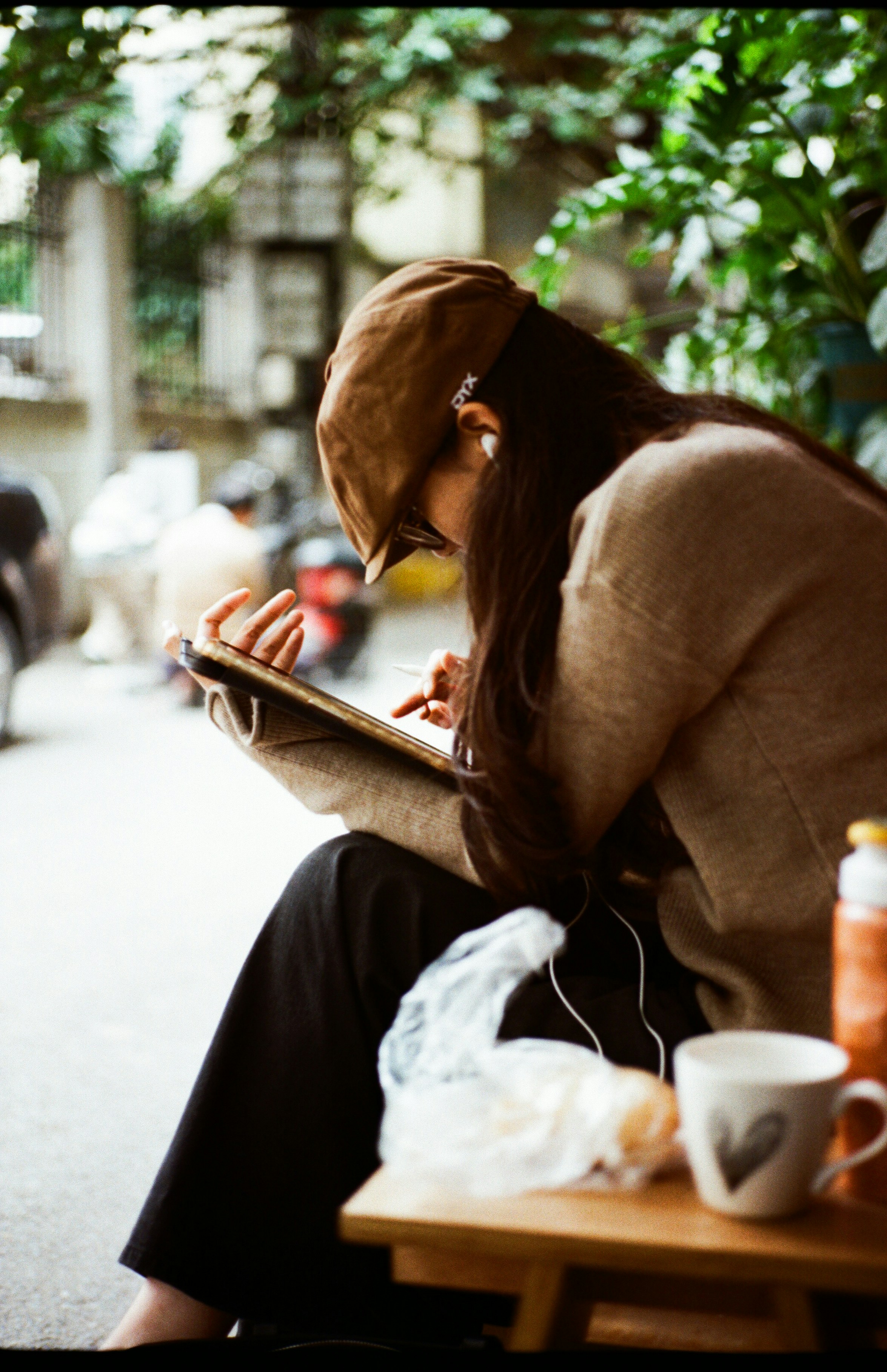 Student with headphones writing