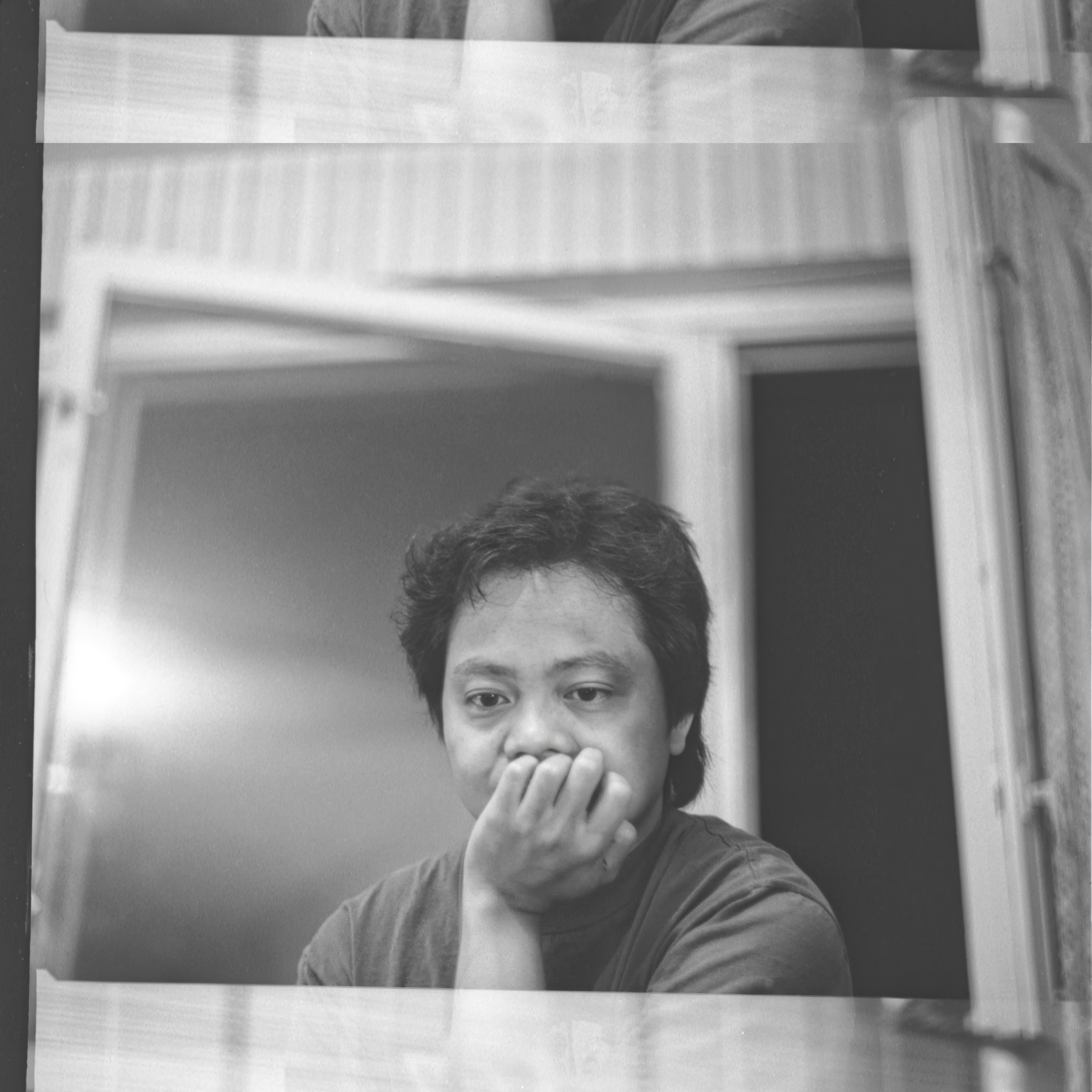 Man with hand on chin looking out window