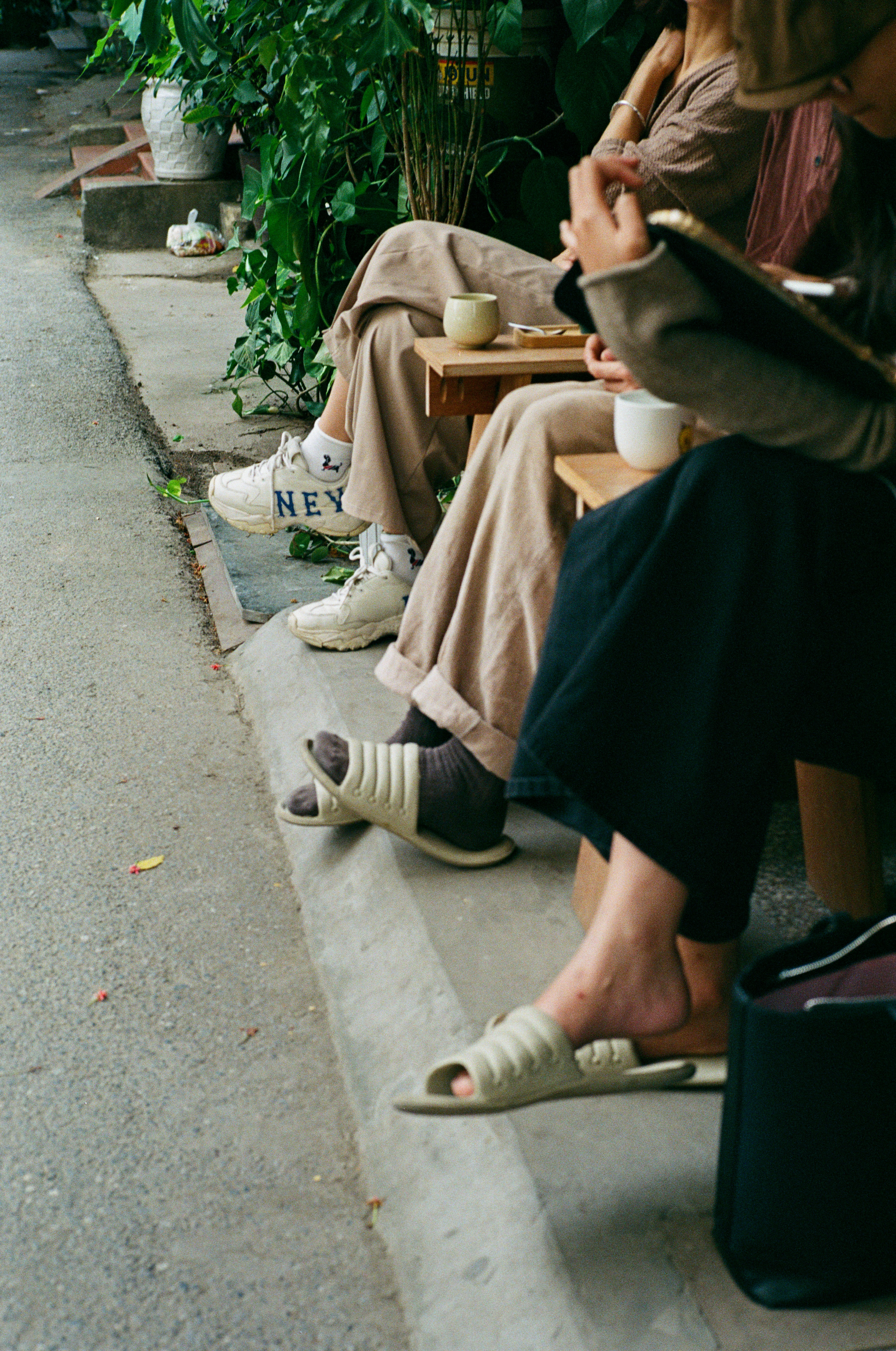 People sitting at a table outside a cafe.