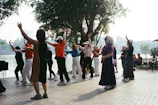 People exercising outdoors by a lake