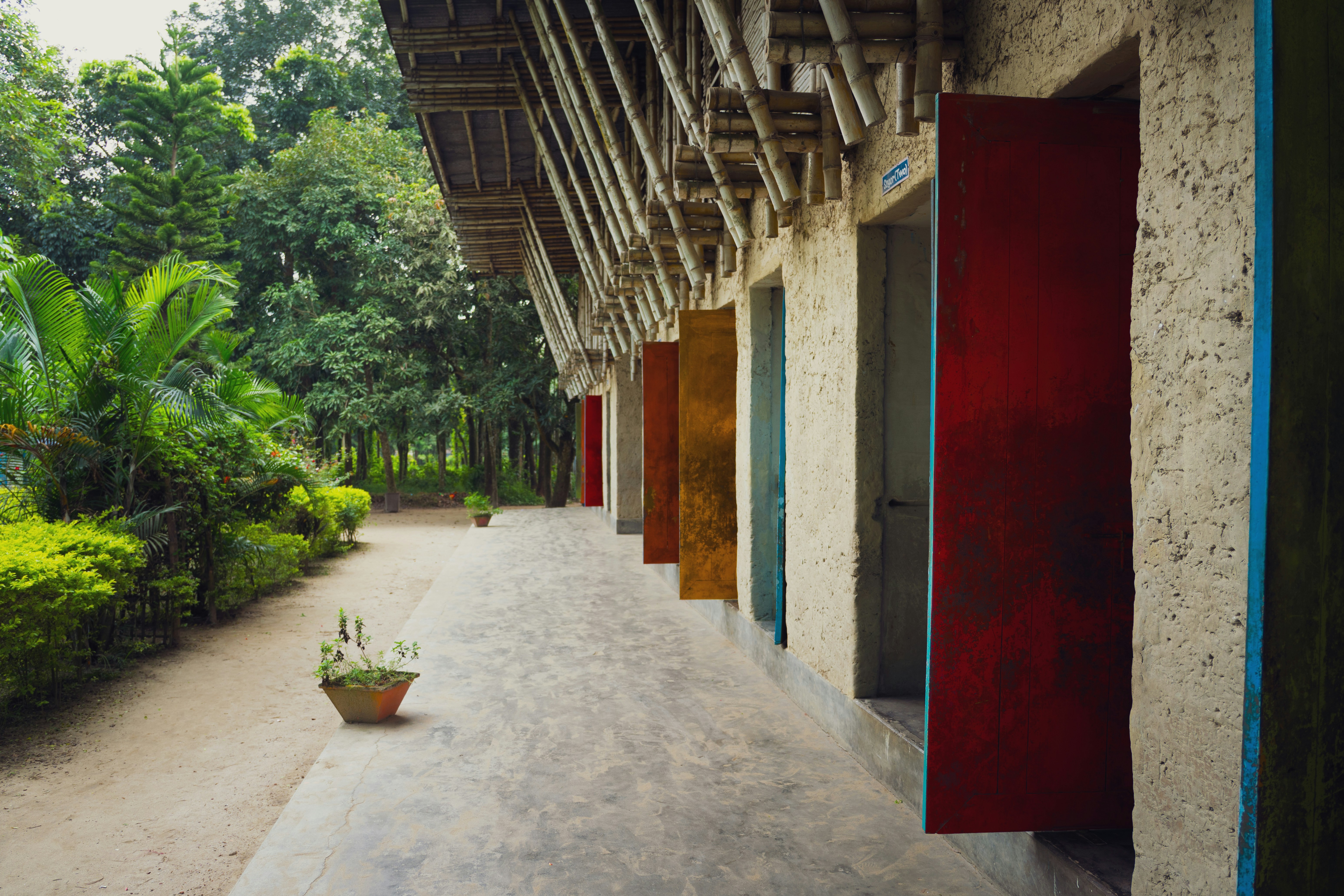 Row of colorful doors along a building facade.