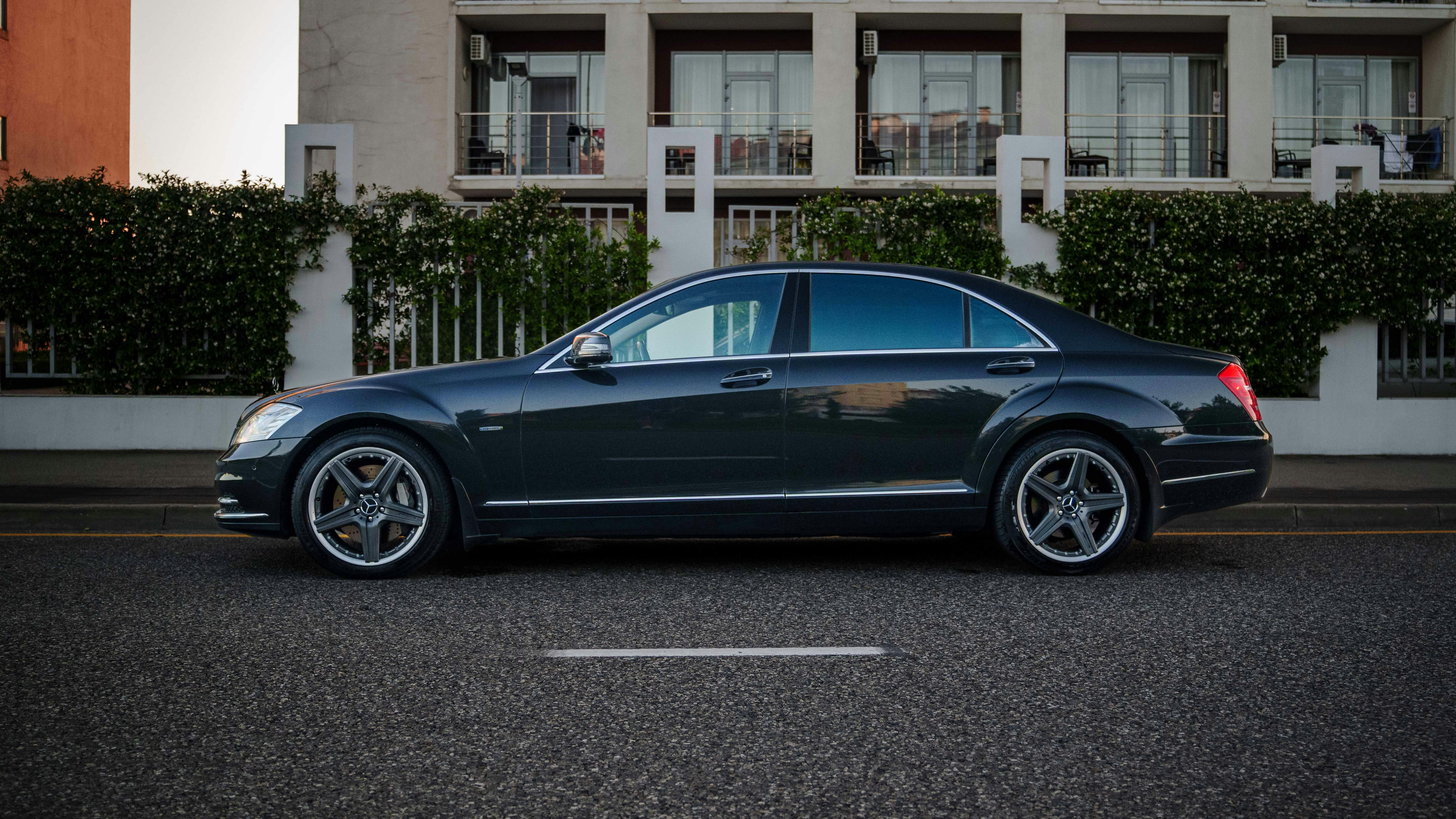 Dark grey luxury sedan parked on city street