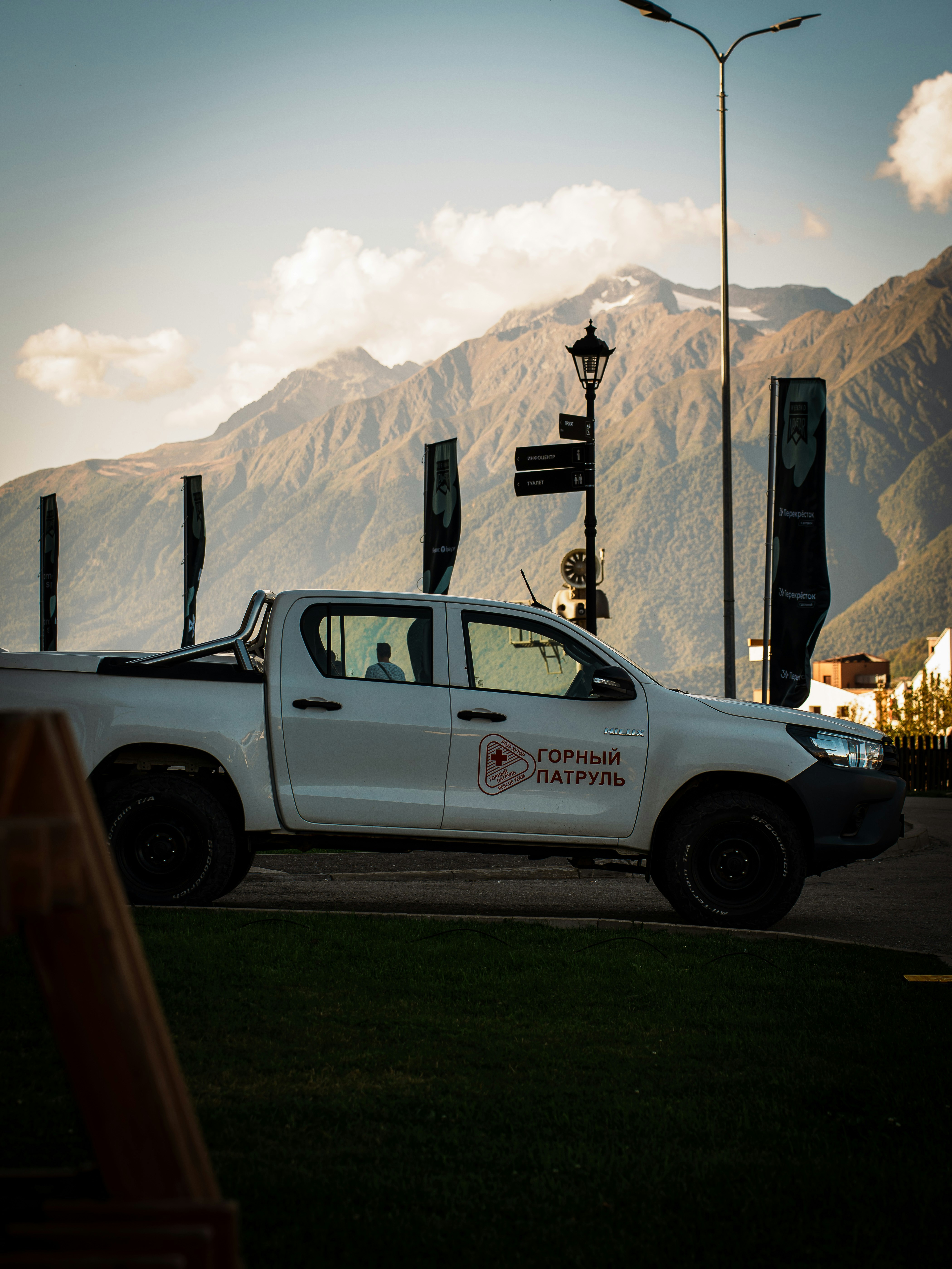 White pickup truck parked with mountains in background