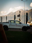 White pickup truck parked with mountains in background