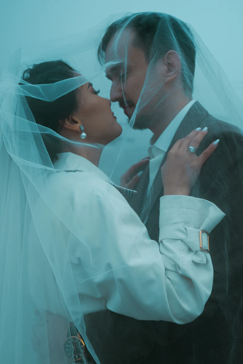 Couple sharing a moment under a veil