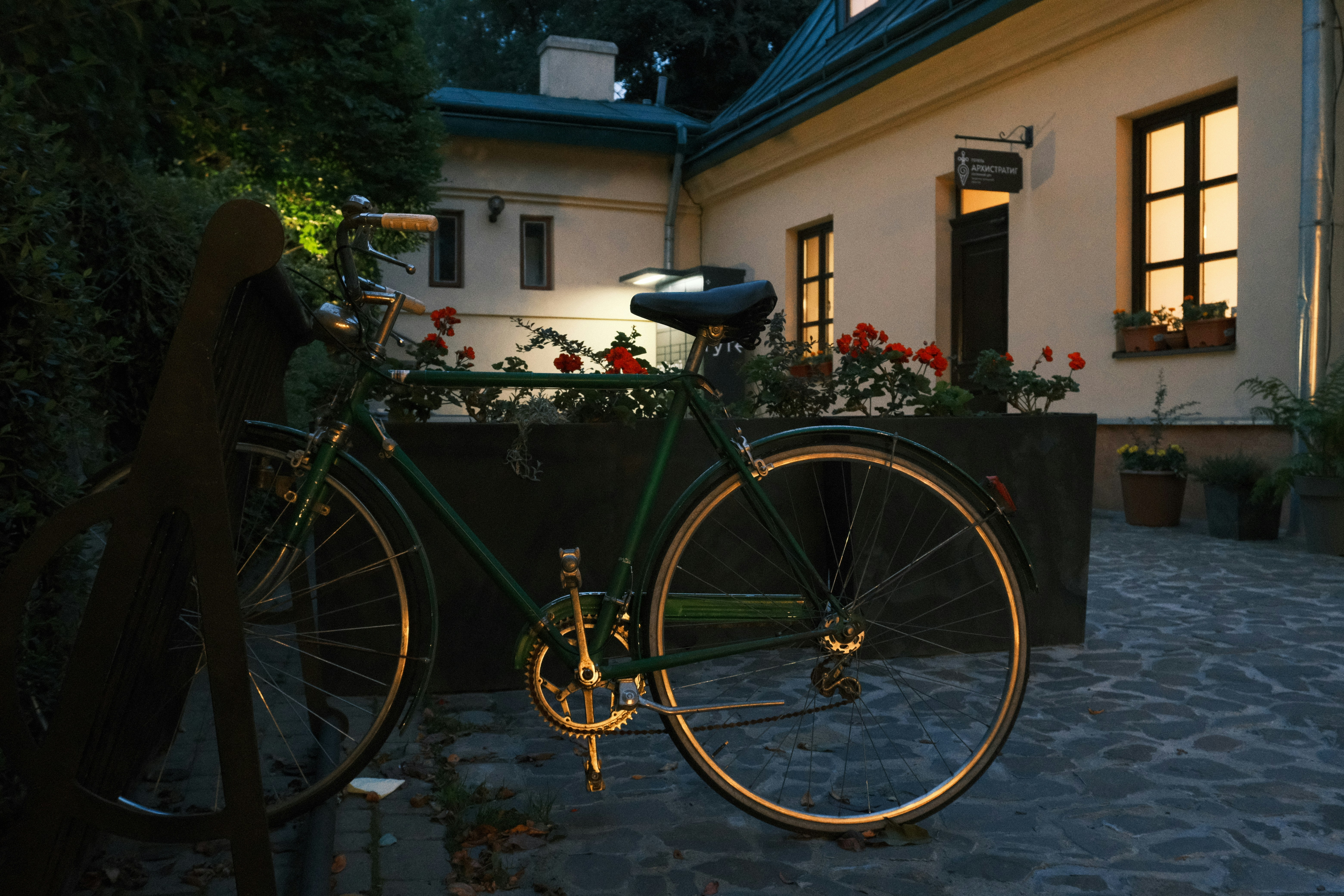 Vintage bicycle parked outside a building at dusk