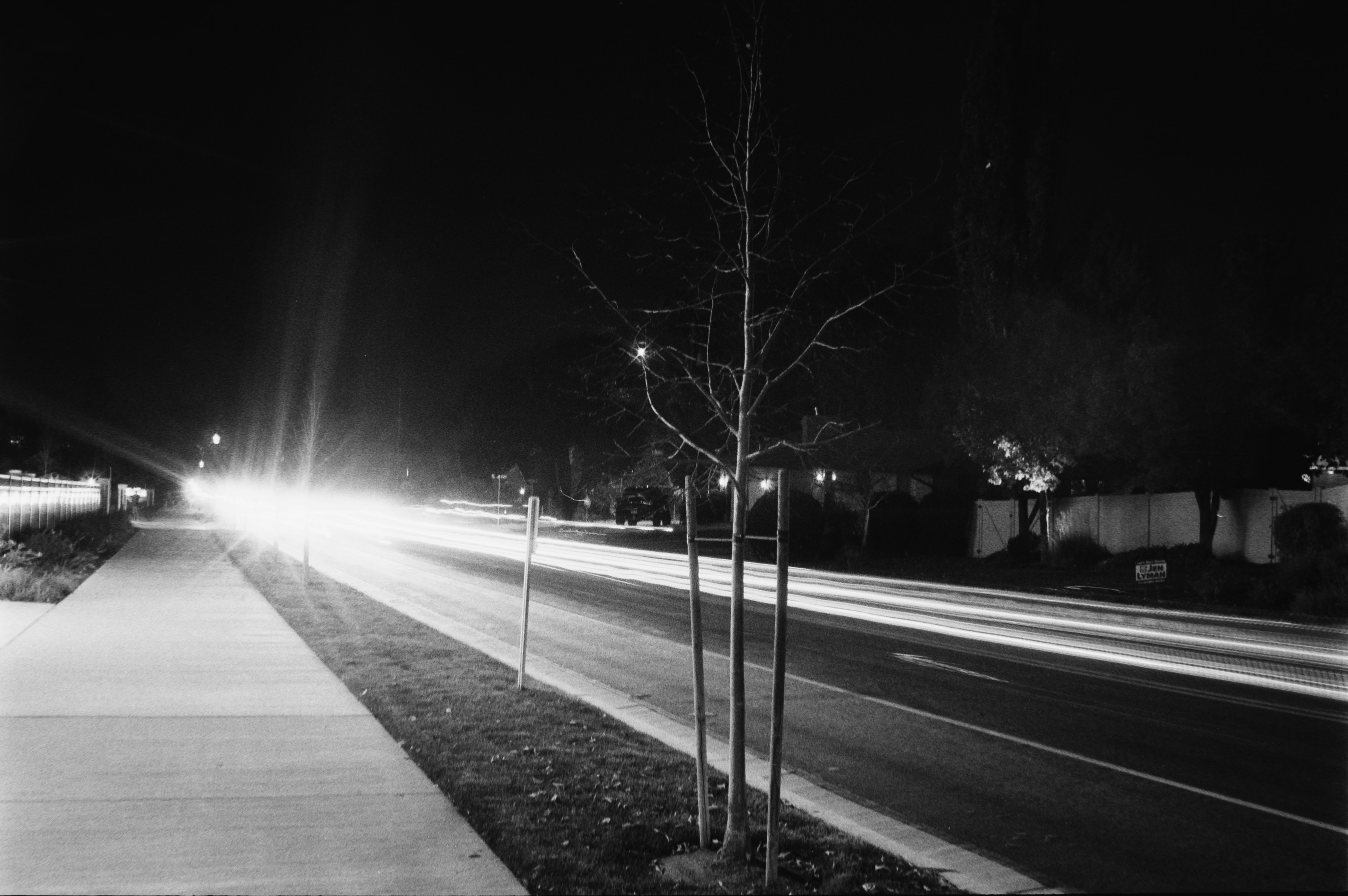 Light trails on a dark road at night