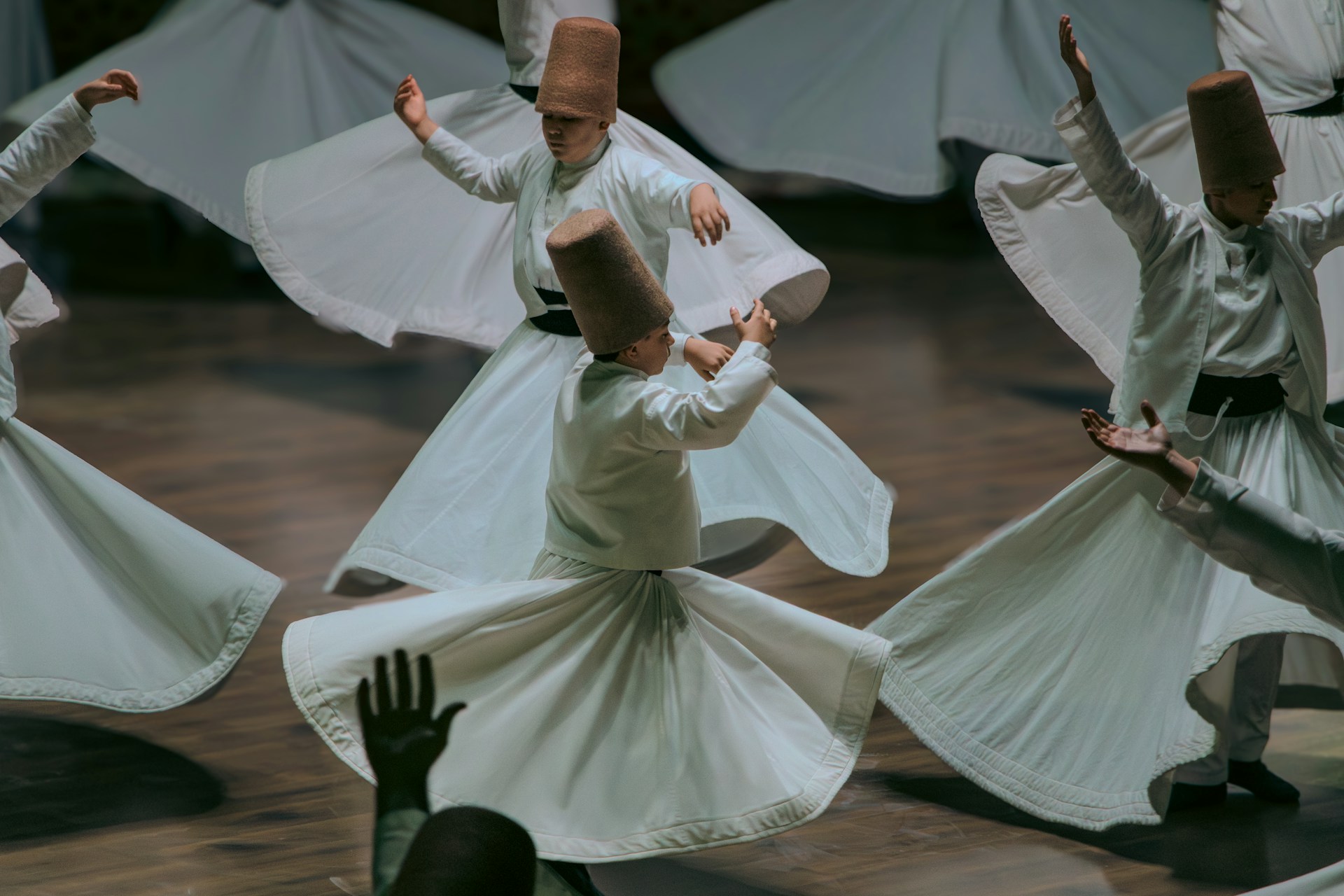 Whirling dervishes perform a spiritual dance in white robes.