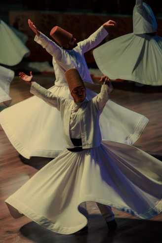 Whirling dervishes in white robes performing a ritual dance