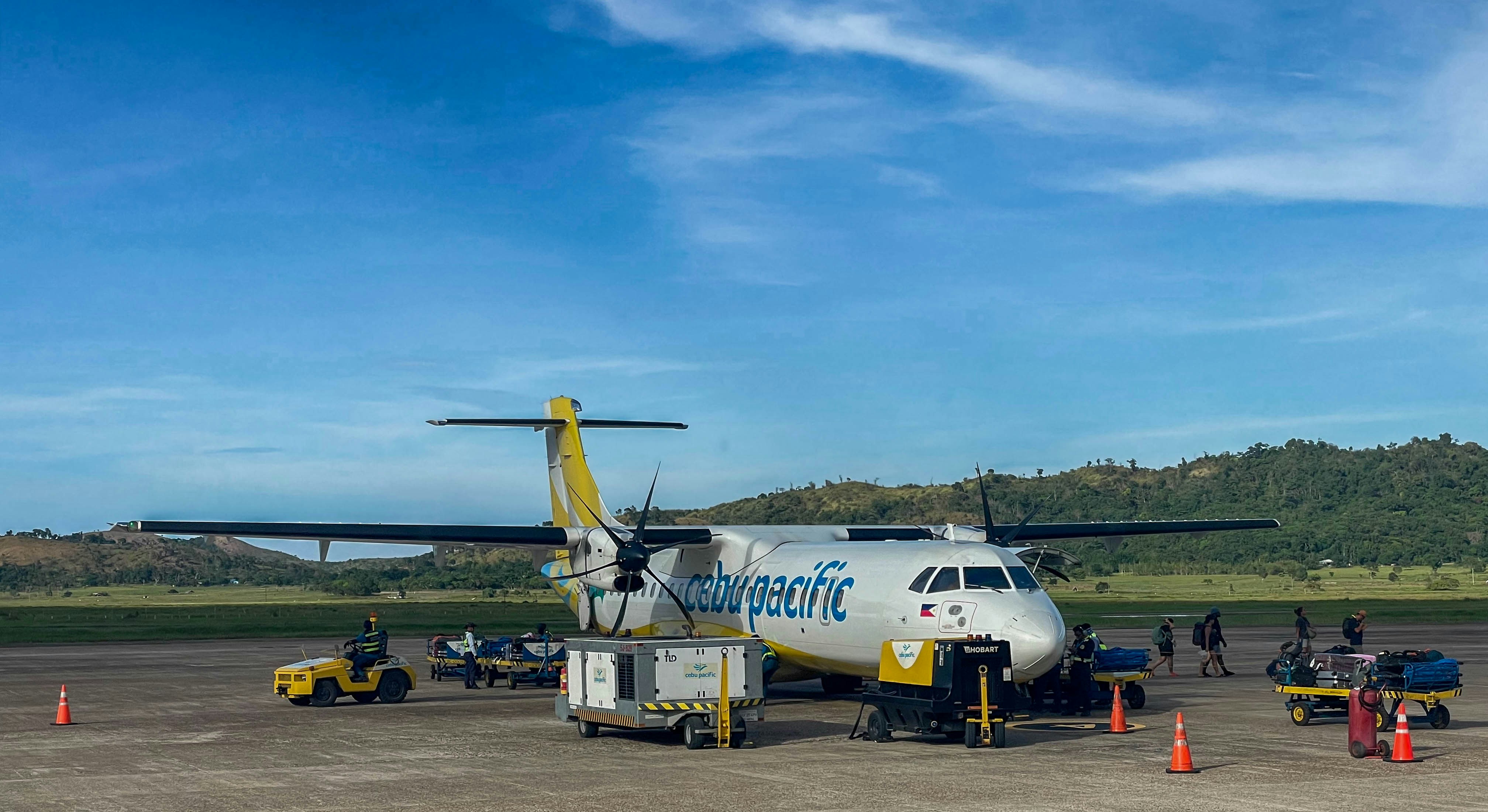 Turboprop airplane parked at an airport tarmac.