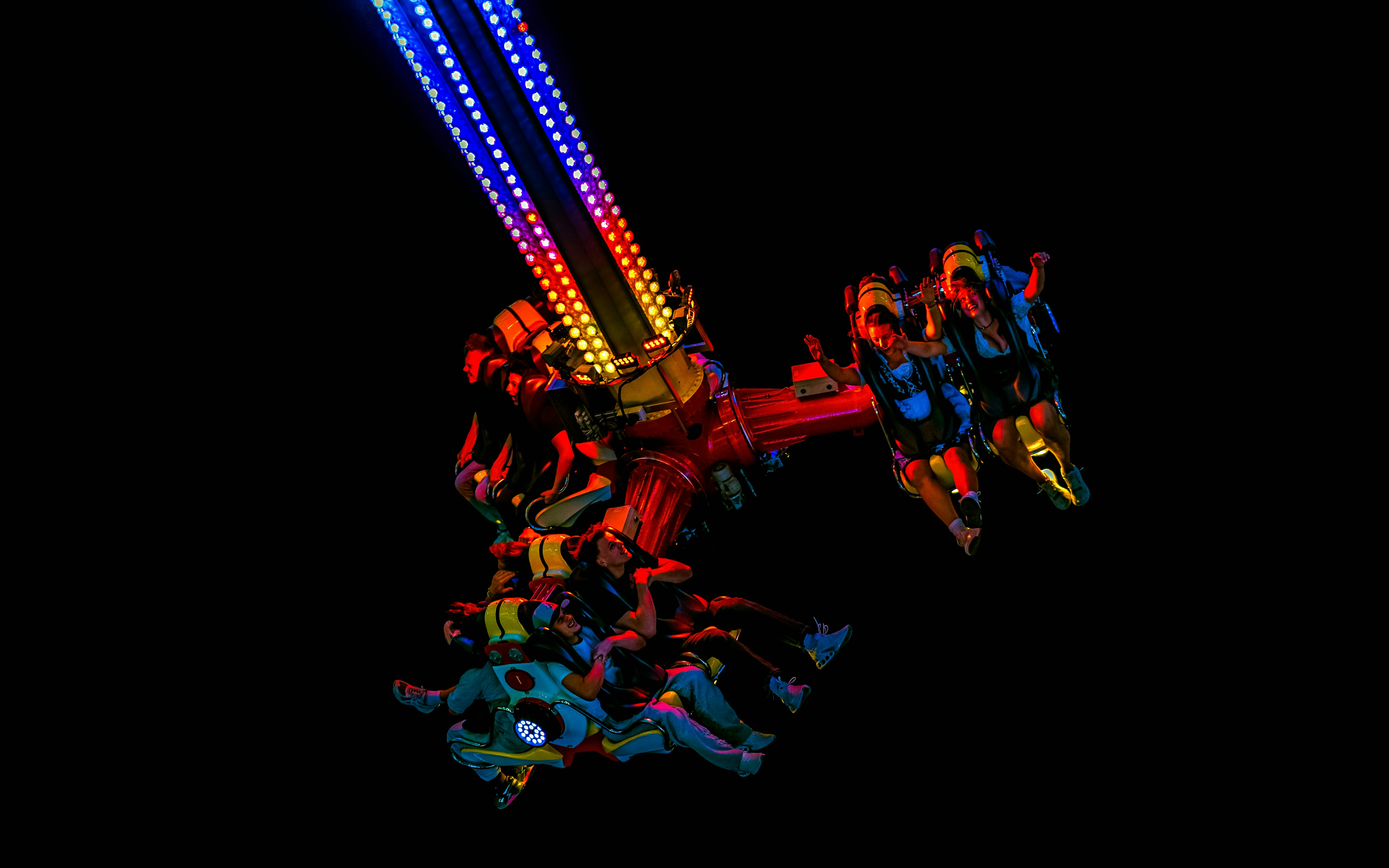 Amusement park ride with colorful lights at night