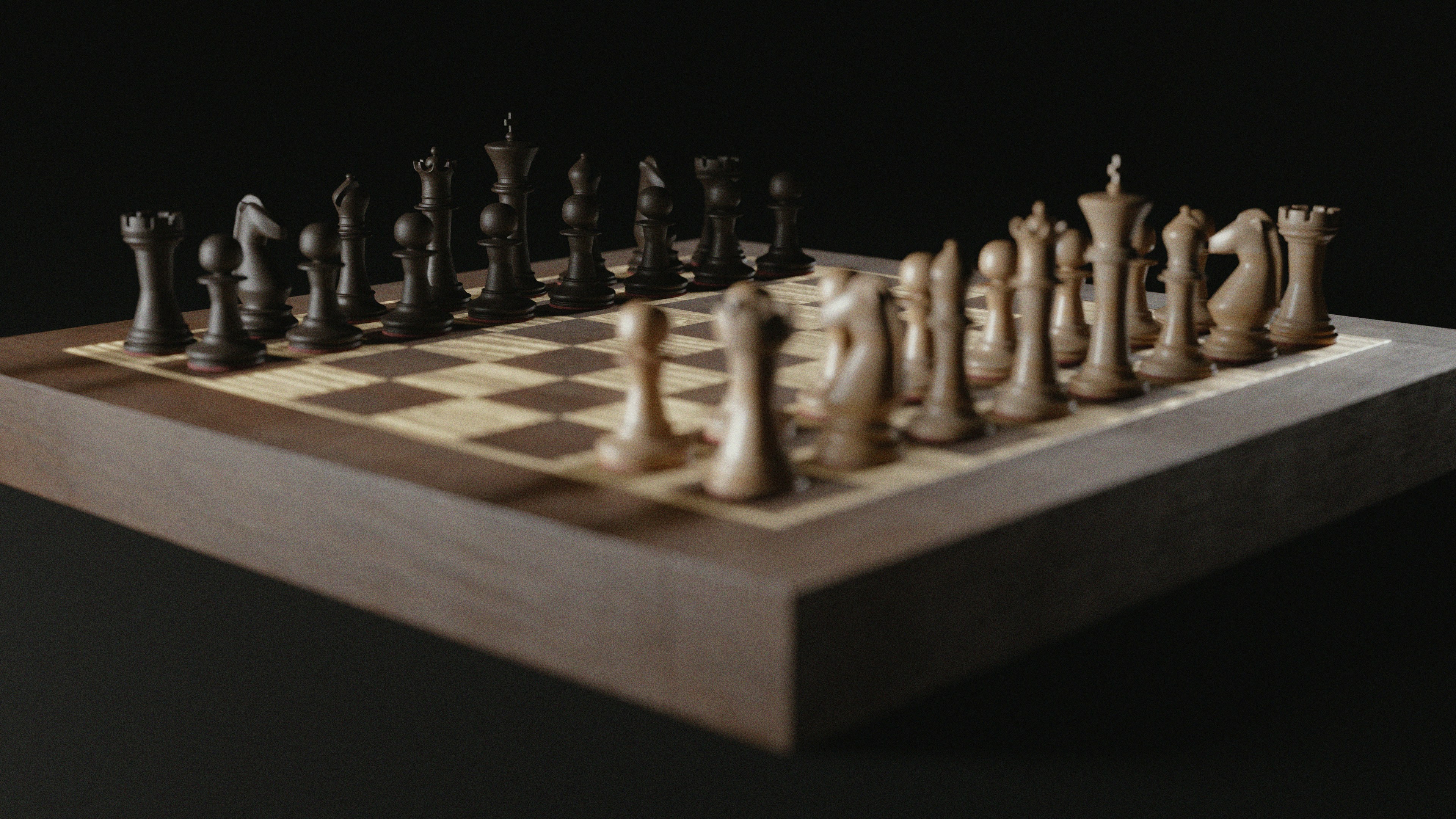 Wooden chess pieces arranged on a board.