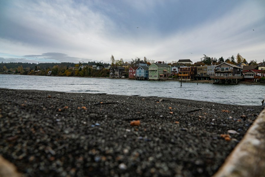 Coupeville's waterfront cottages across Penn Cove seen from a pebble beach