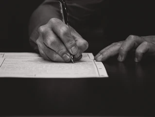 Hand writing with a fountain pen on paper.
