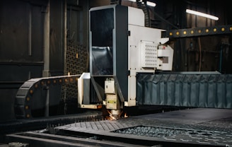 Industrial laser cutter working on metal sheet