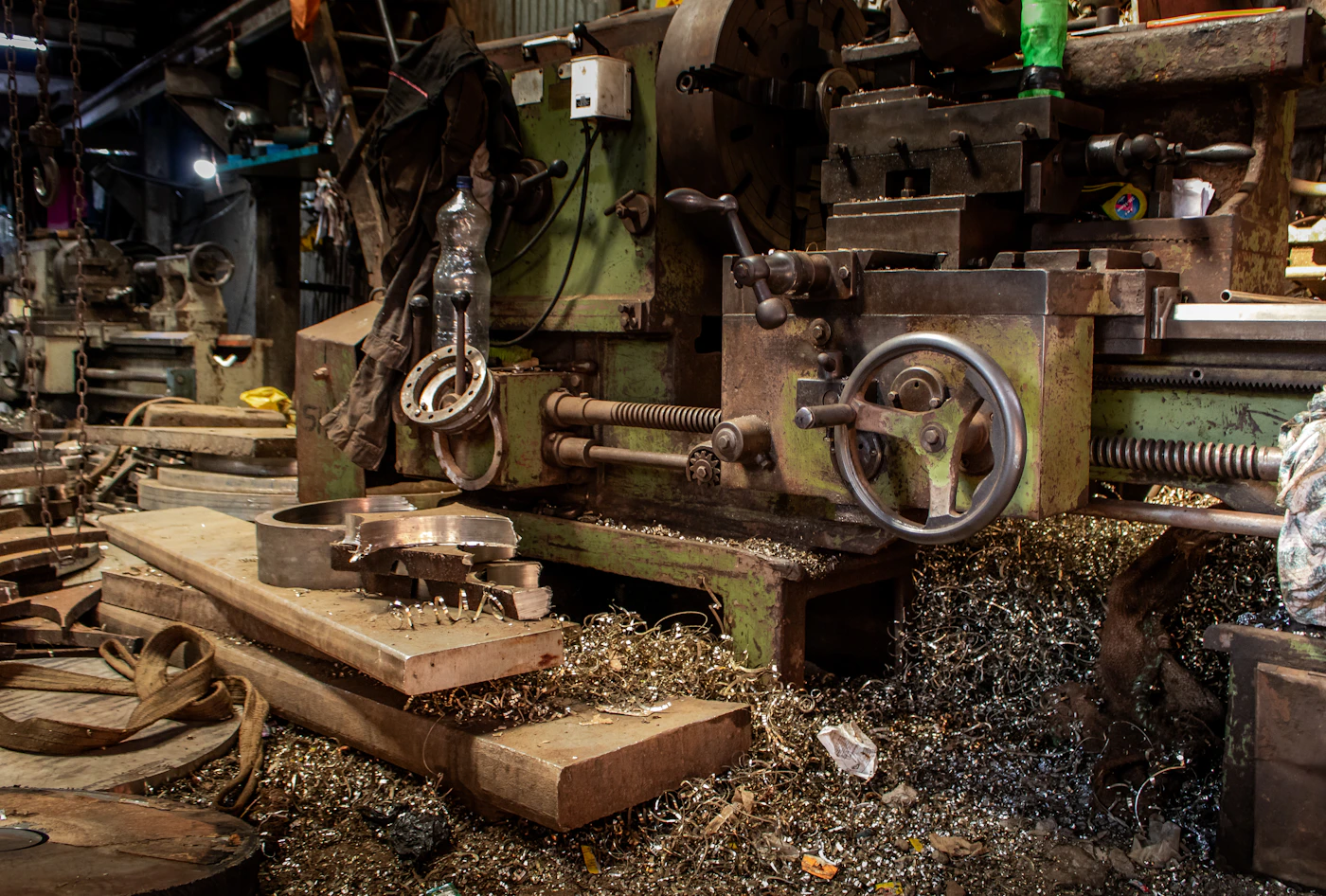 Round metal stock being prepared on industrial machining equipment