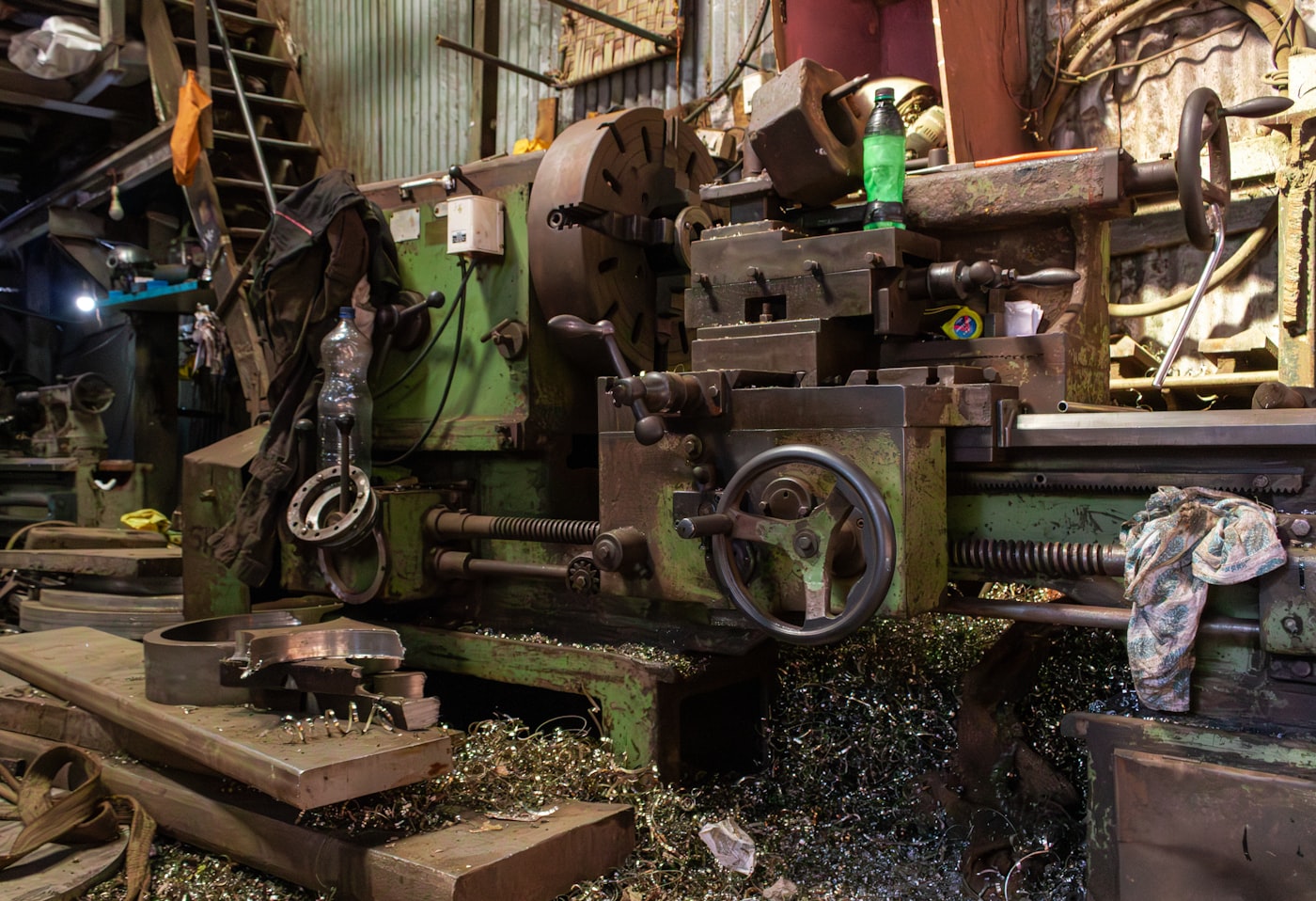 Metal lathe machining a component in the workshop
