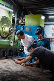 Workers operating a large industrial machine together