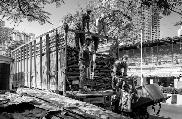 Workers loading a truck in Mumbai — bookings and commercial goods