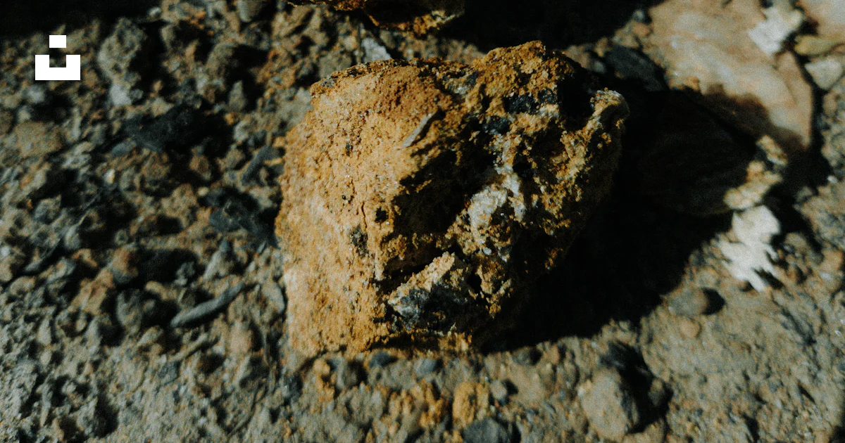 Primer plano de dos rocas rugosas y terrosas sobre tierra seca. foto ...