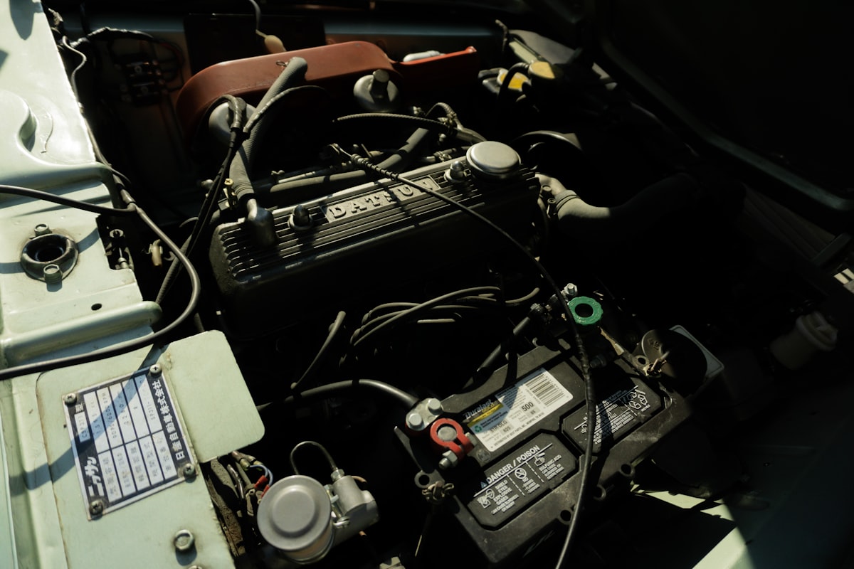 Close-up view of a car engine and battery under diagnostics