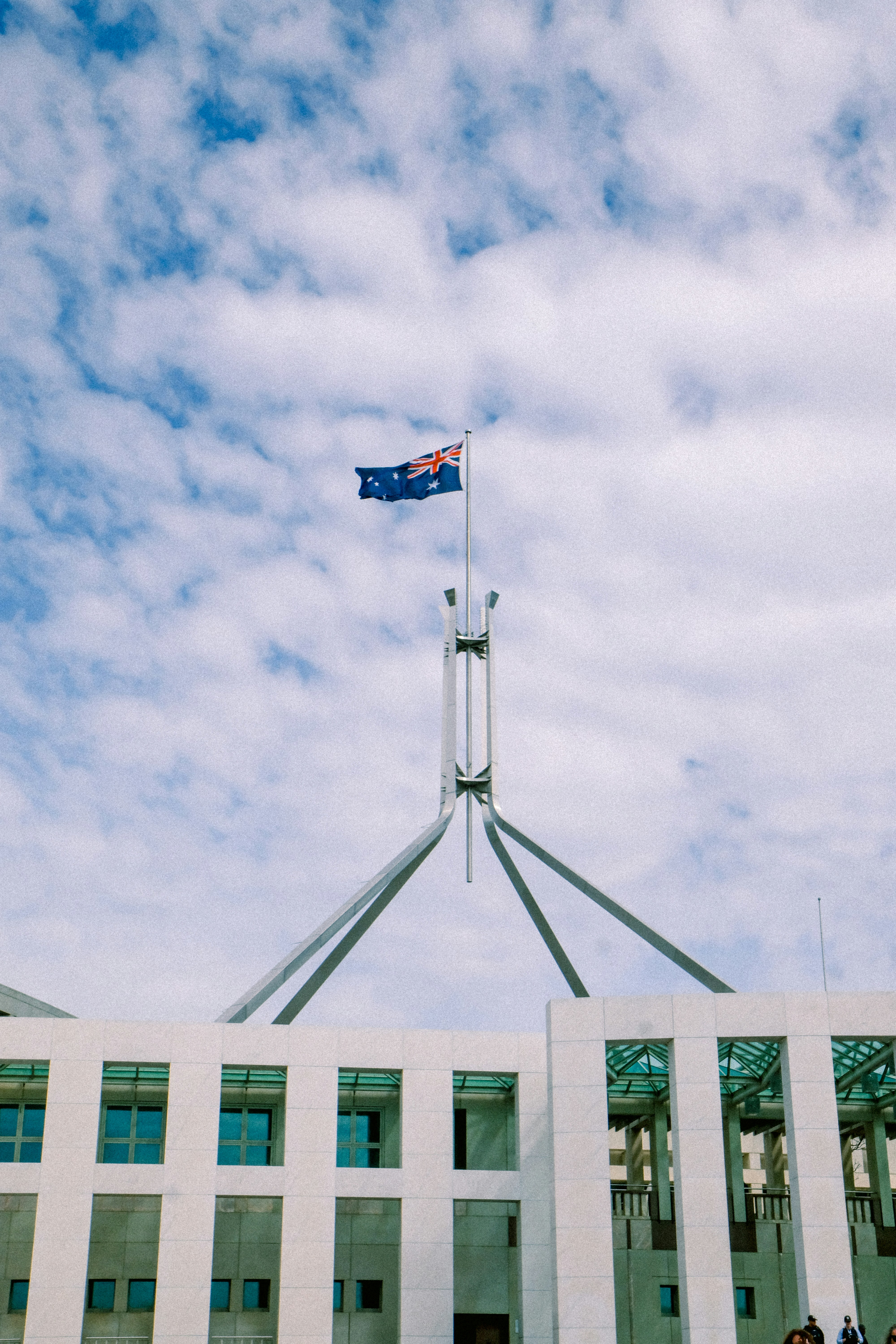 Australian flag flies atop parliament house building