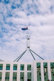 Australian flag flies atop parliament house building