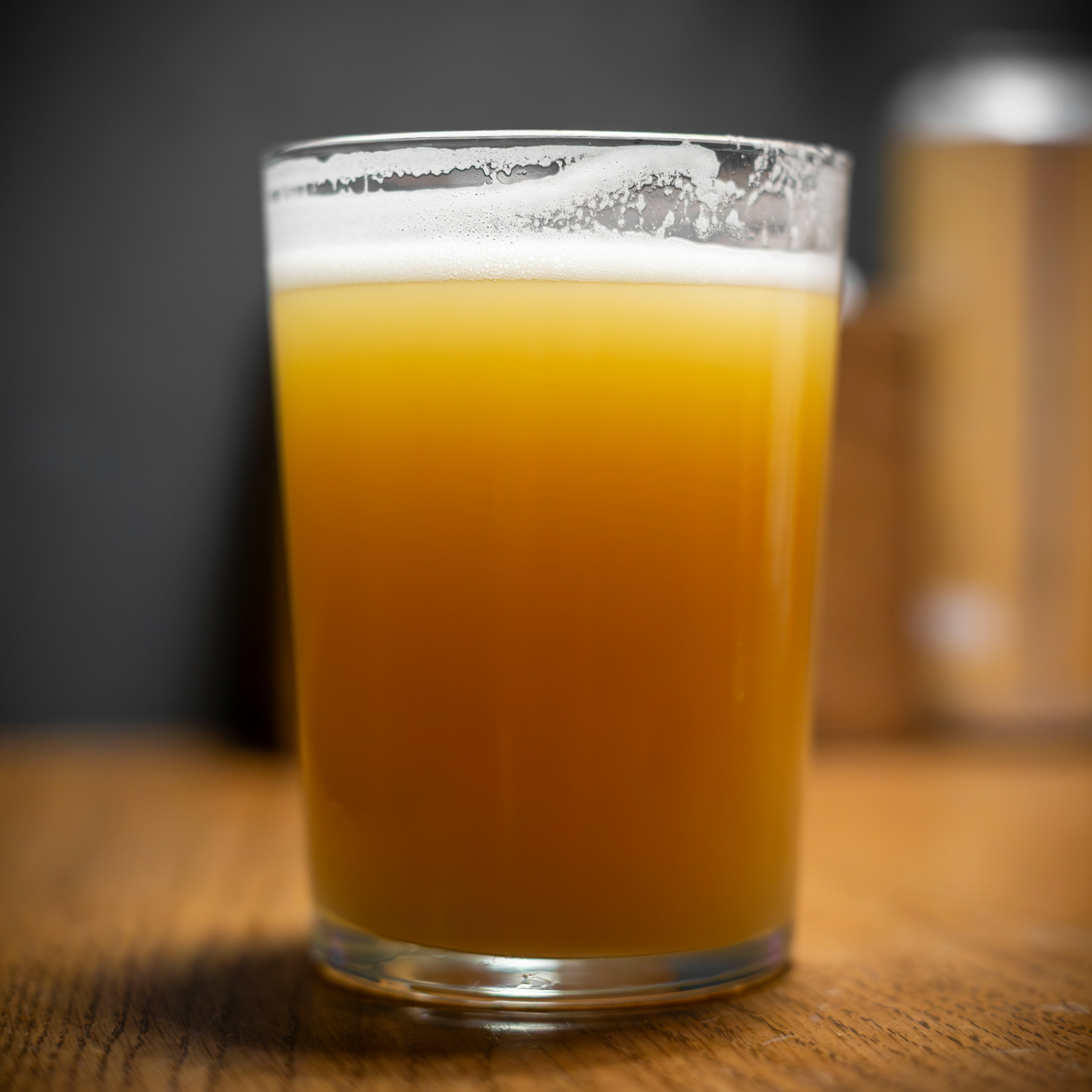 A glass of amber beer with white foam