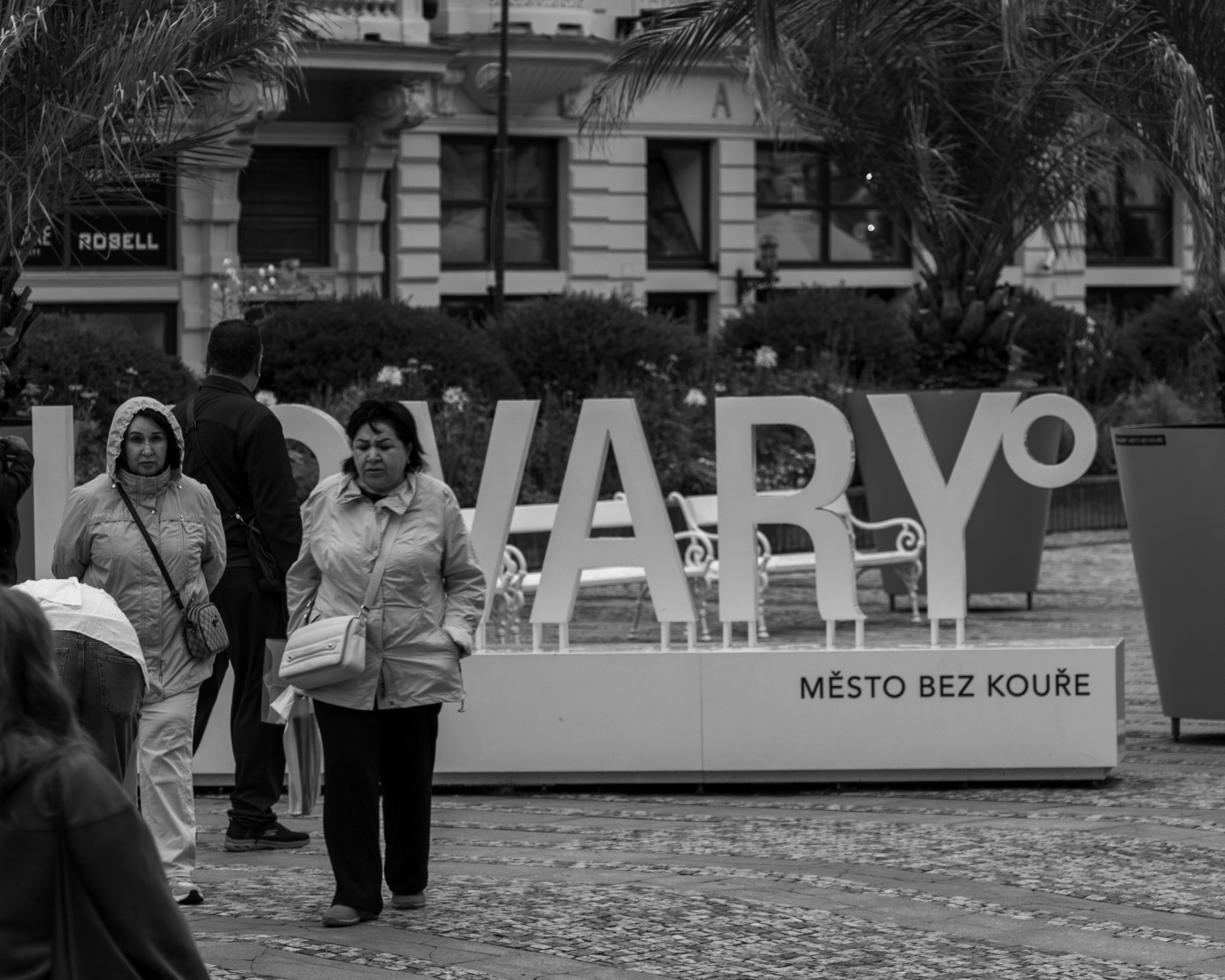 A police officer typing on a computer, looking focused, with social media icons subtly visible on the screen, showing a mix of online and offline work.