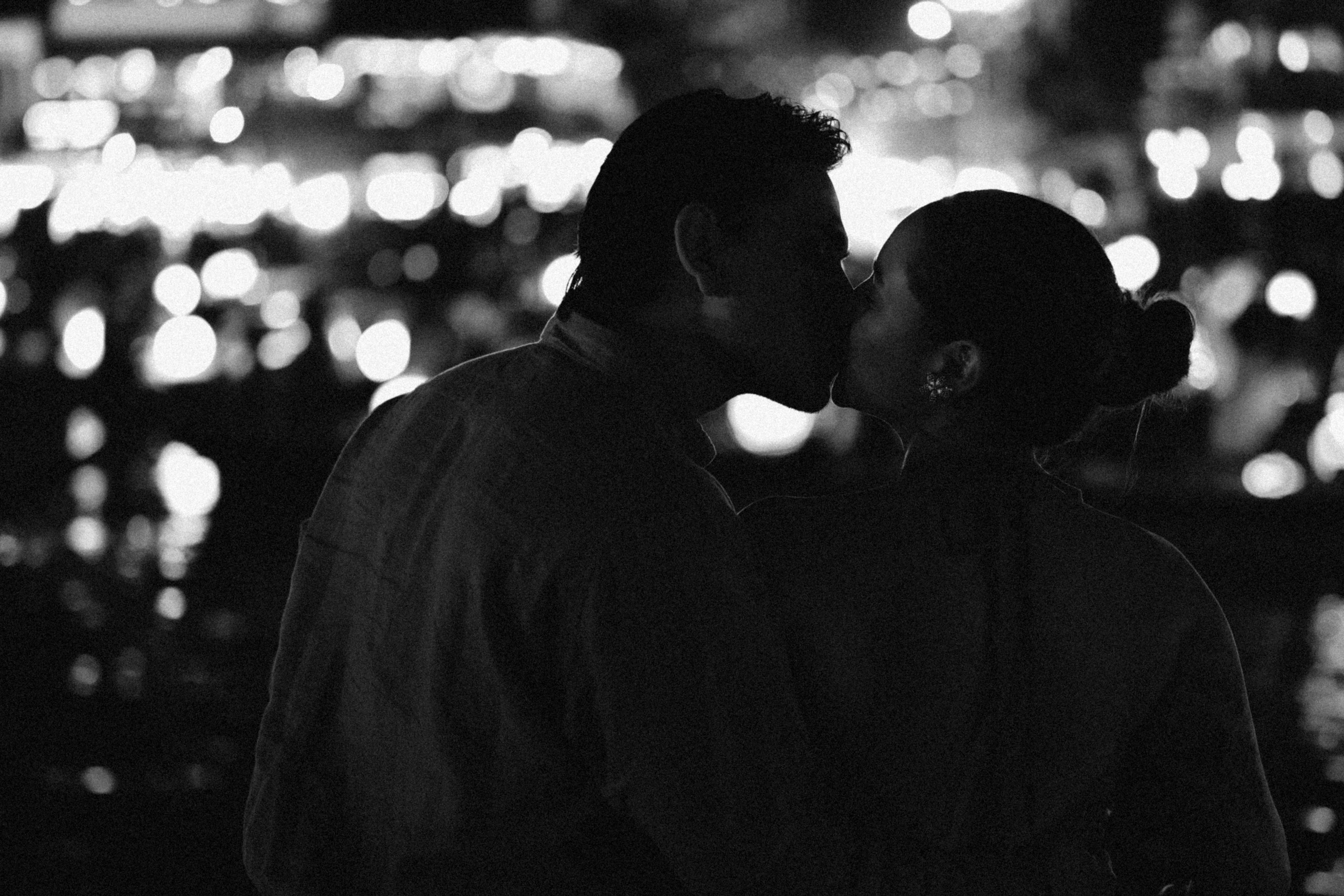 Couple kissing in city lights