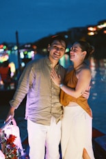 A happy couple on a boat at night