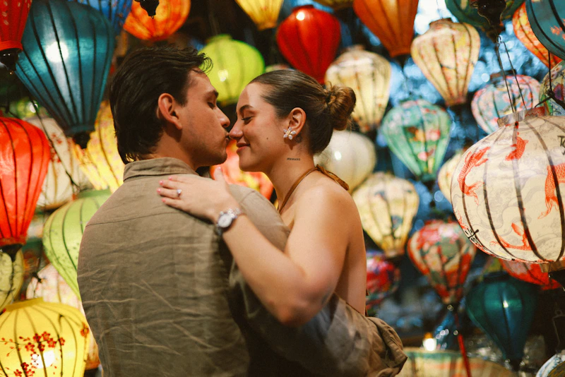 Couple embracing in front of colorful lanterns