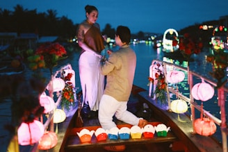 Man proposes to woman in a boat at night
