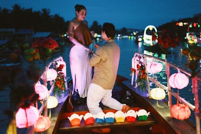 Man proposes to woman in a boat at night