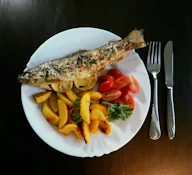 Whole roasted fish with potatoes and tomatoes