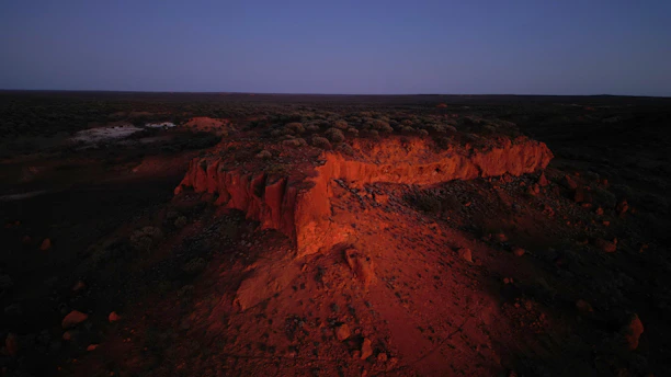 Canyon edge illuminated by sunset light at dusk