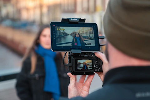 Filming a woman with a blue scarf outdoors