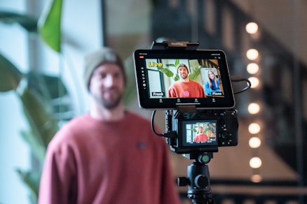 Man filming a video with camera and monitor