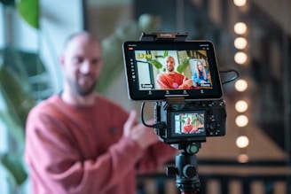 Man filming a video call on a camera.