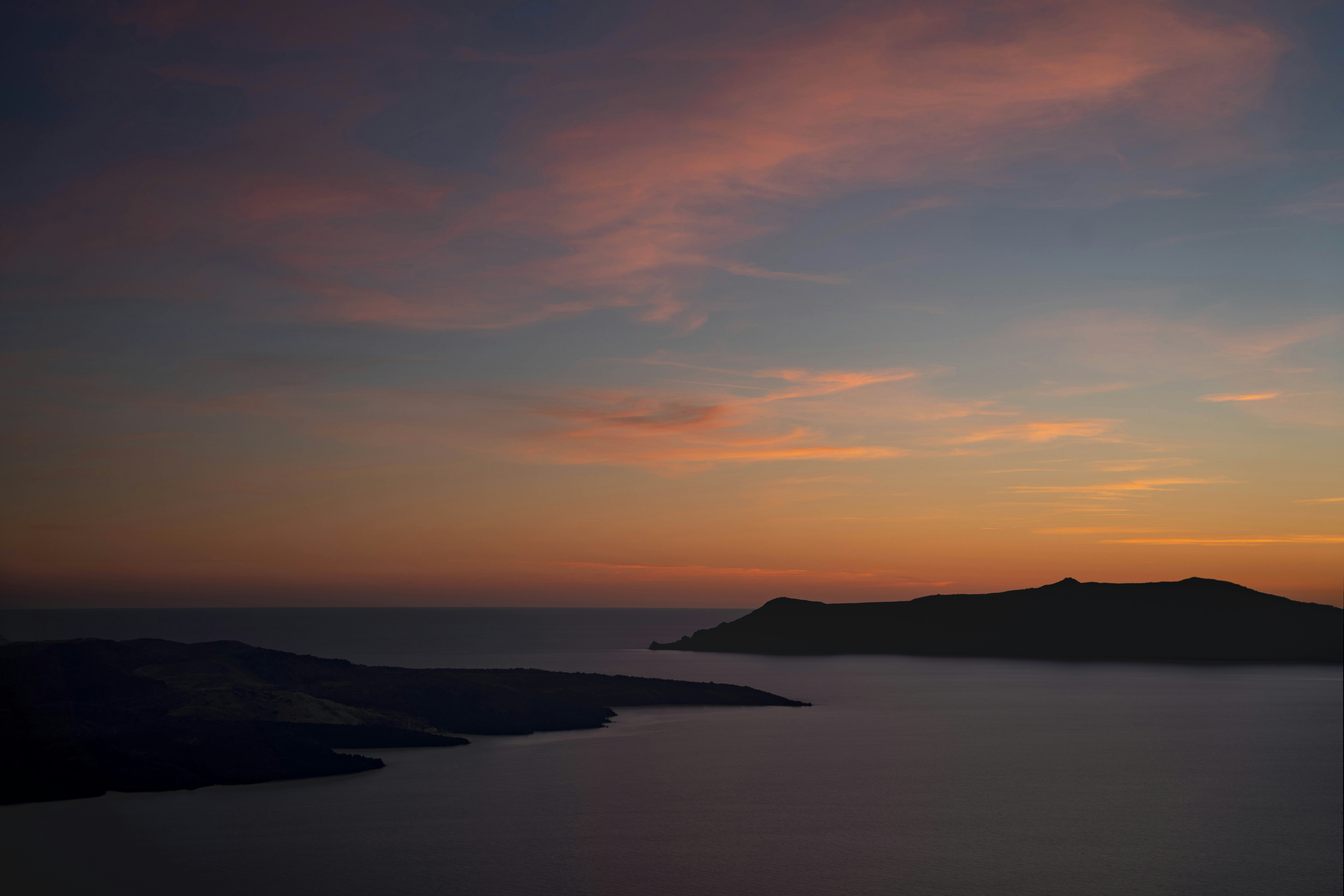 Islands silhouetted against a colorful sunset sky