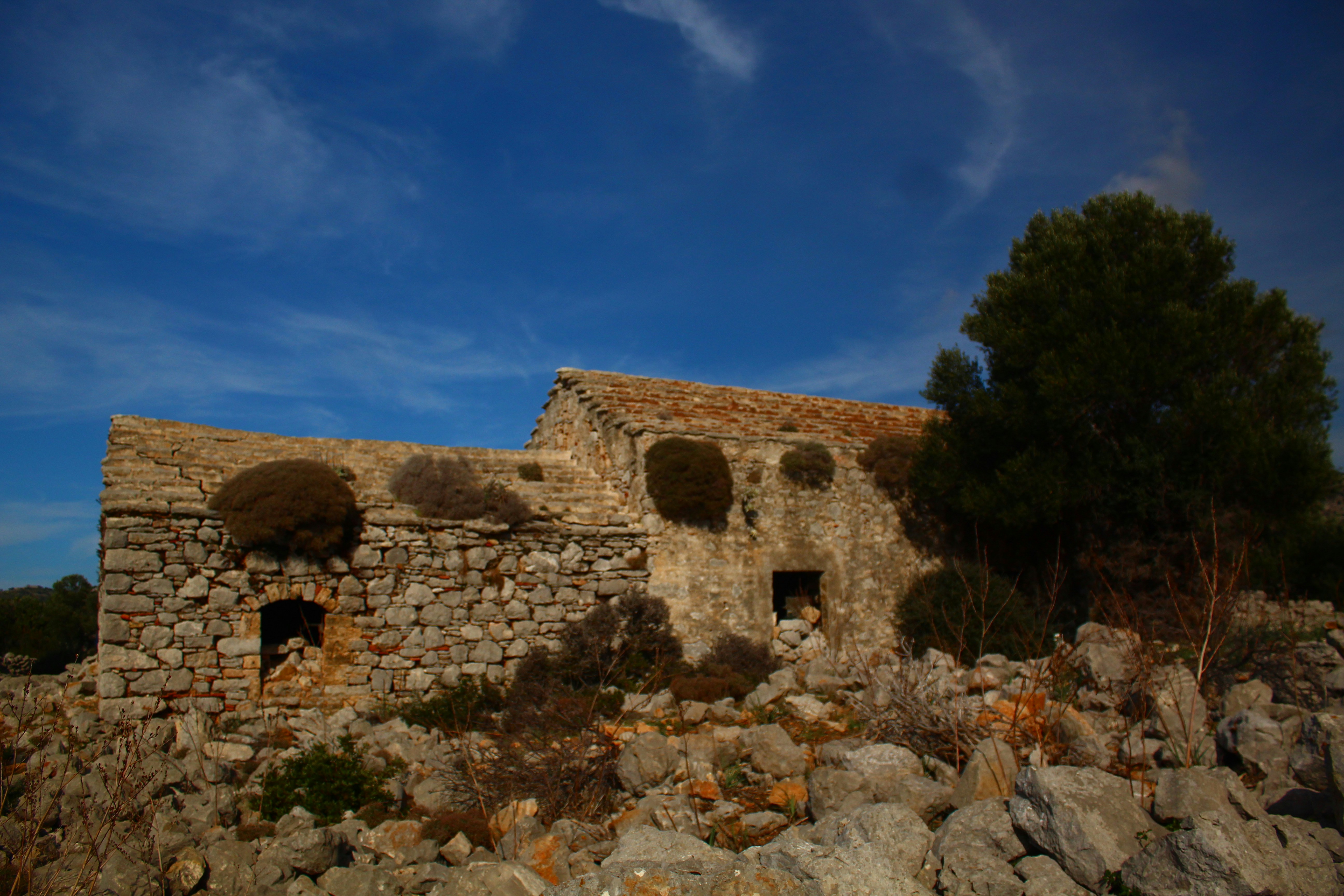 Old stone building under a blue sky.
