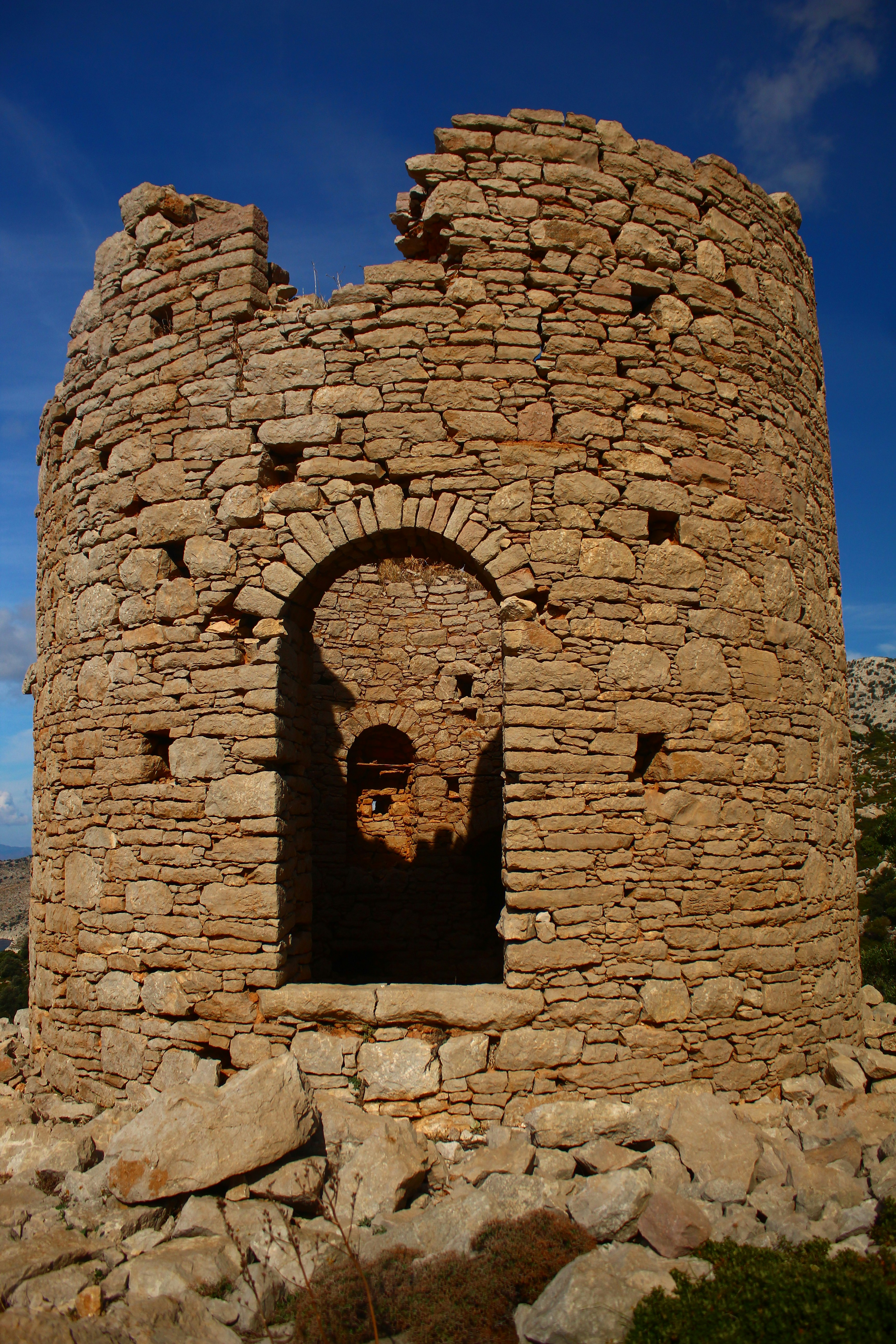 Ancient stone tower ruins against a blue sky