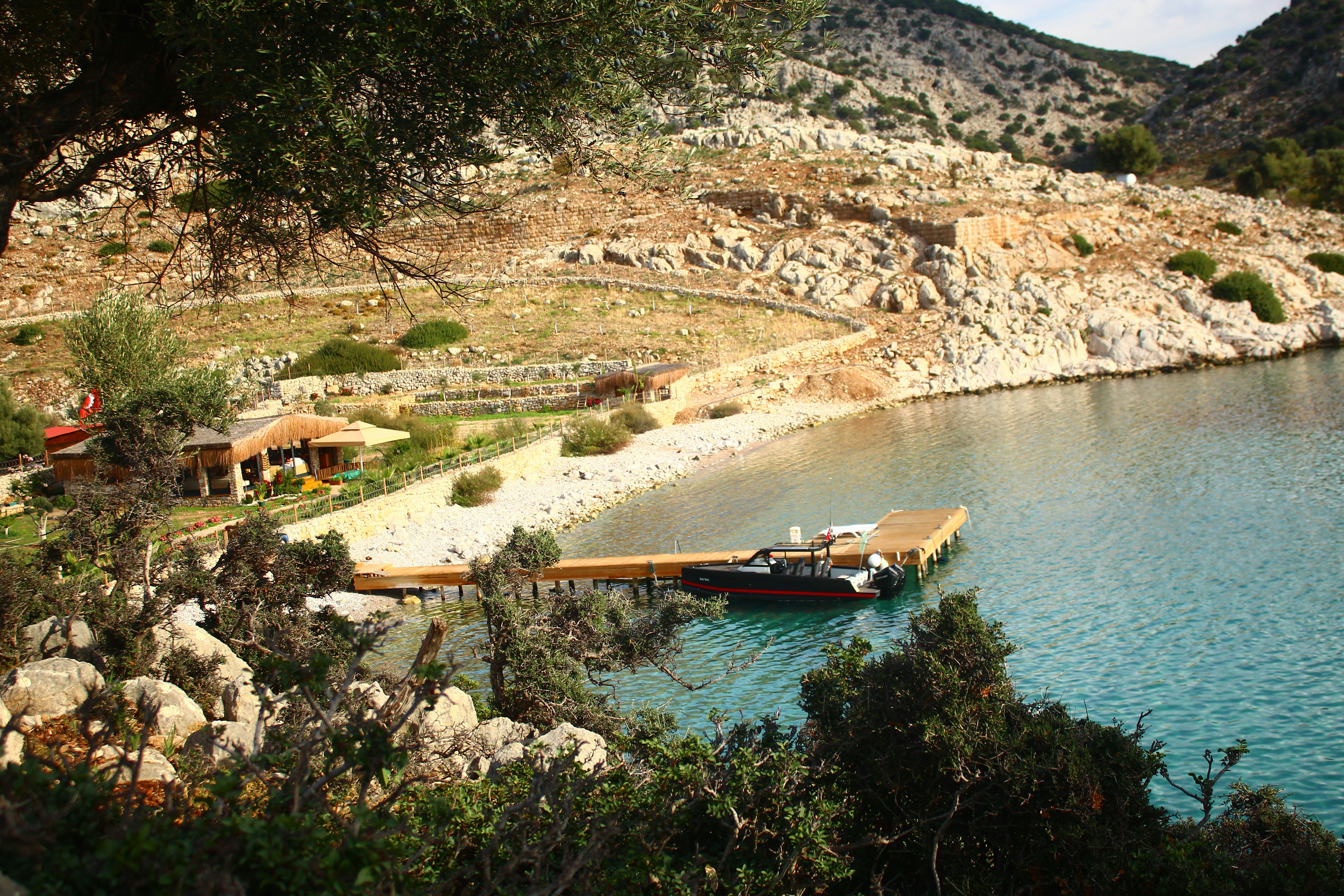 A secluded bay with a small dock and boat.