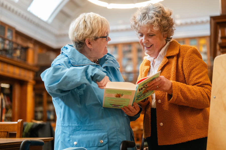 Two people going through a book together at a table